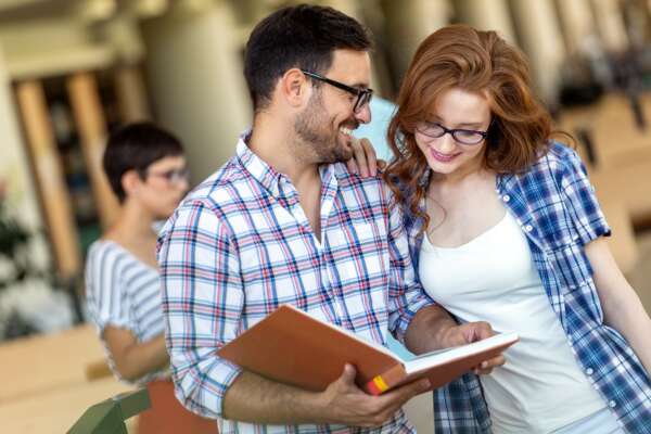 Education friendship people concept. Group of happy students learning together in college library