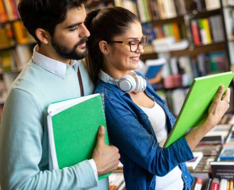 Group of happy college students studying in the school library. Education people university concept